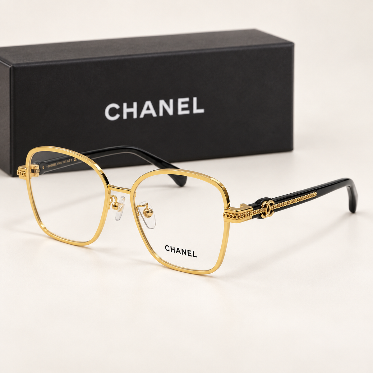 CC Gold Square Eyeglasses — front-left view with brand box
